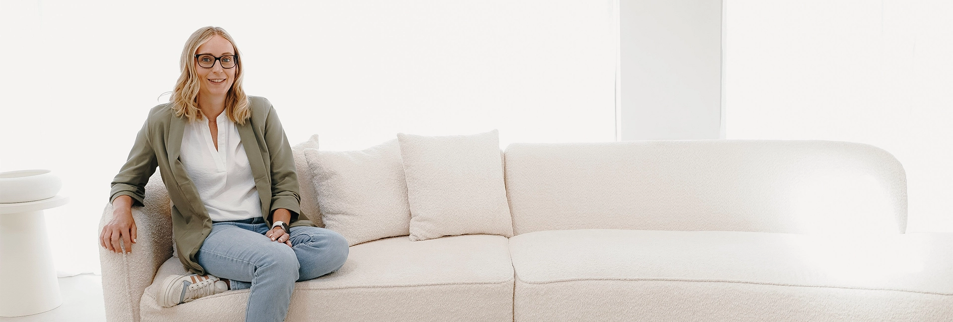 Charlotte sat on a white sofa