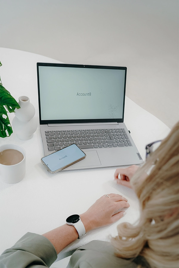 Laptop and phone with Account8 wallpaper